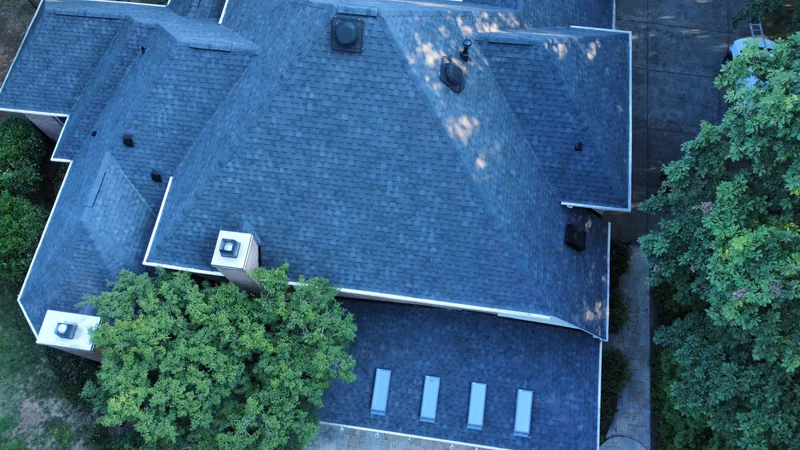 Overhead view of a completed roof with intersecting slopes, chimneys and skylights