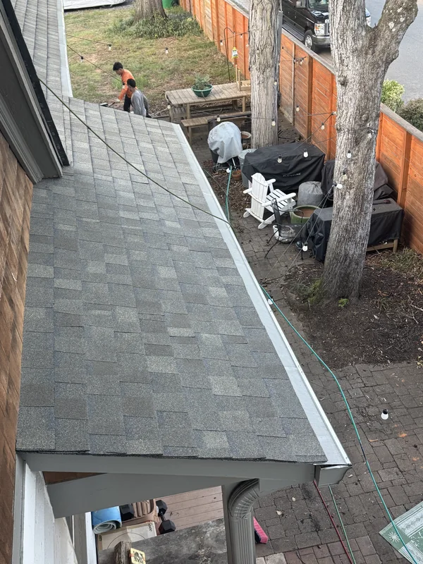 Gray porch roof with a white gutter cover along the eave